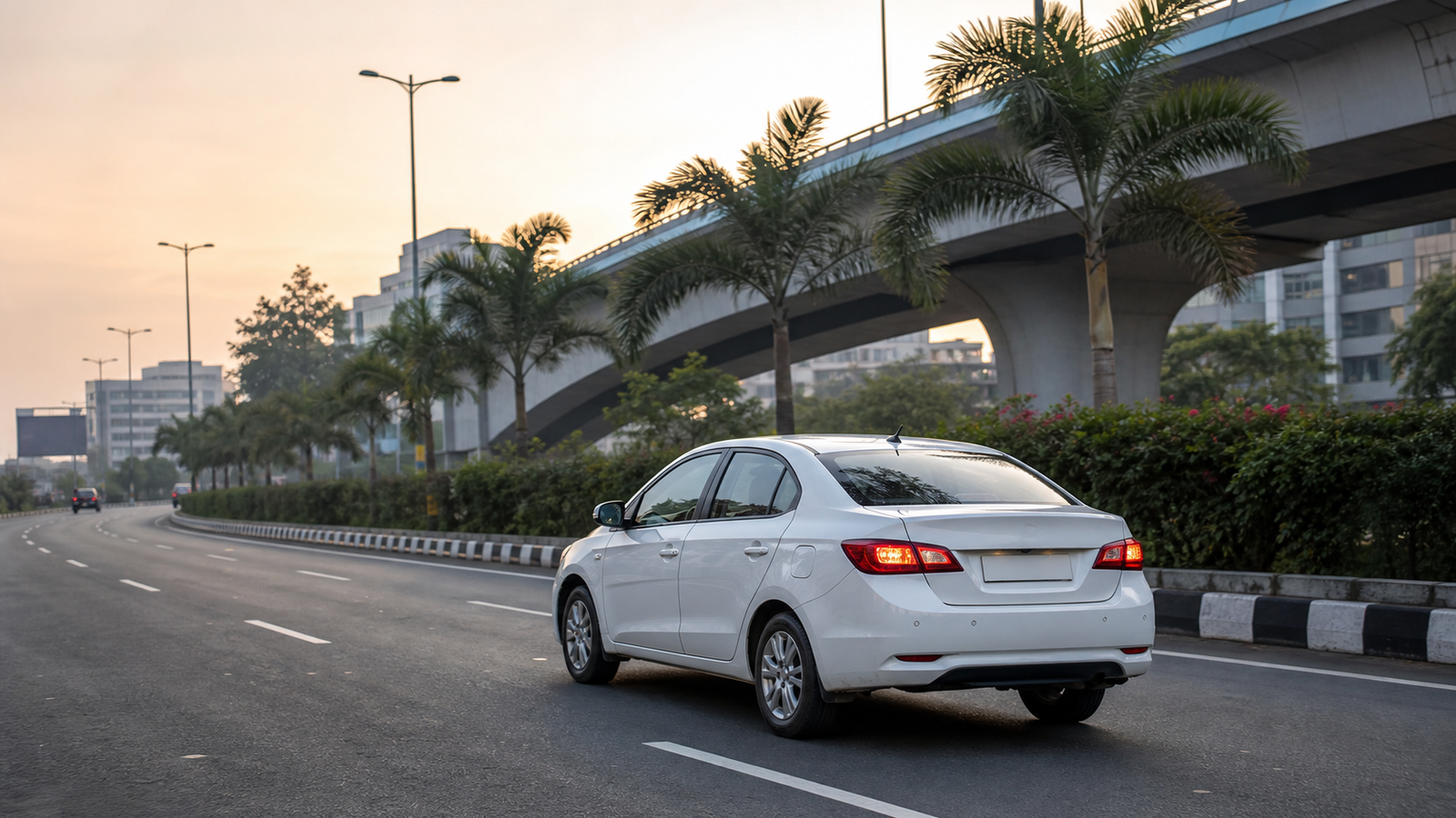 White taxi on a Chennai city road at dawn for outstation pickup