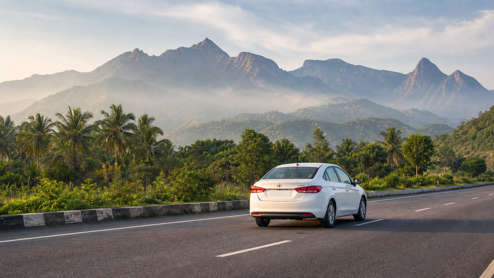 White sedan taxi on a scenic Coimbatore road near the Western Ghats